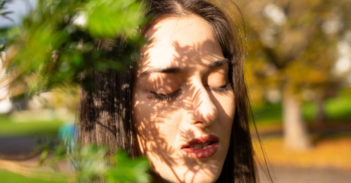 A woman sits at her kitchen table with her eyes closed and both hands pressed flat on the surface, using a grounding technique to calm an anxiety spiral.